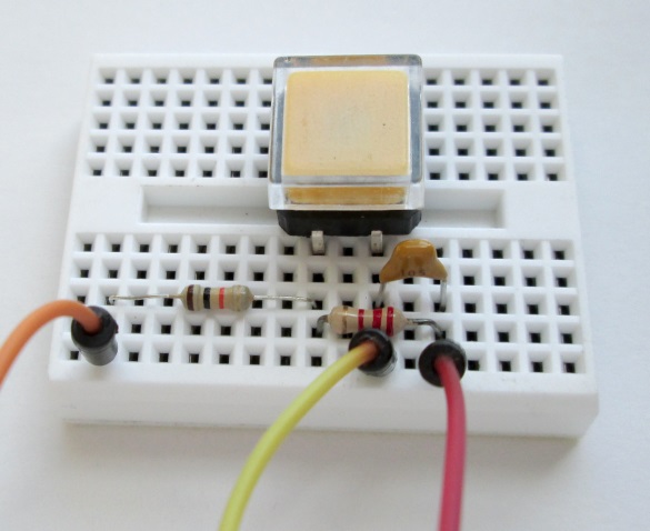 Start Stop switch with debouncing circuit is arranged on a breadboard