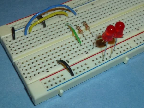 Remove your Microstick for a minute and make sure your breadboard matches the following picture. Then make sure your neighbors breadboard matches the picture.